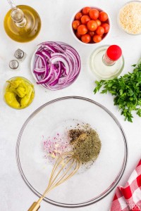 red onion, sugar and spices in a large glass mixing bowl with a whisk