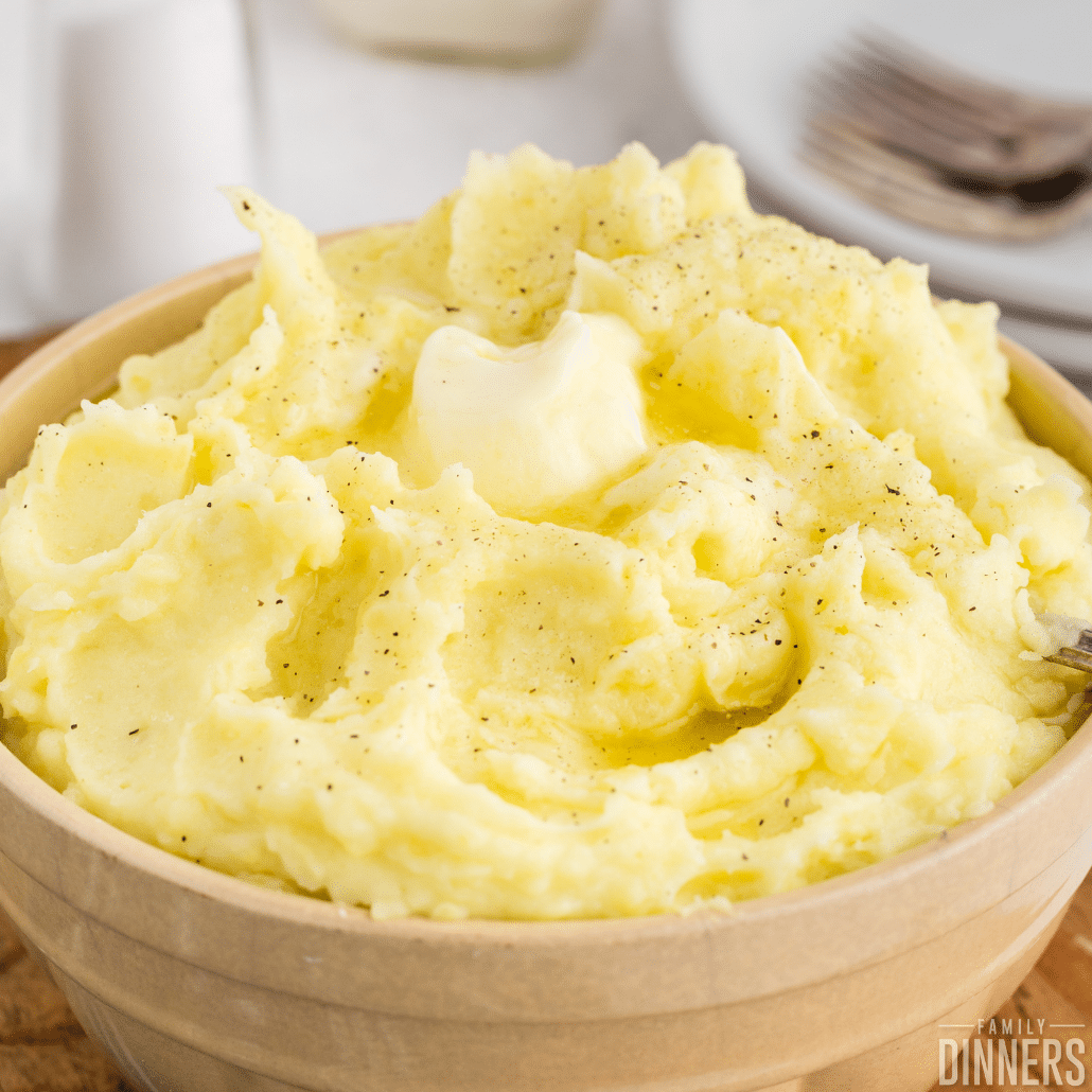 bowl of creamy mashed potatoes with butter on top