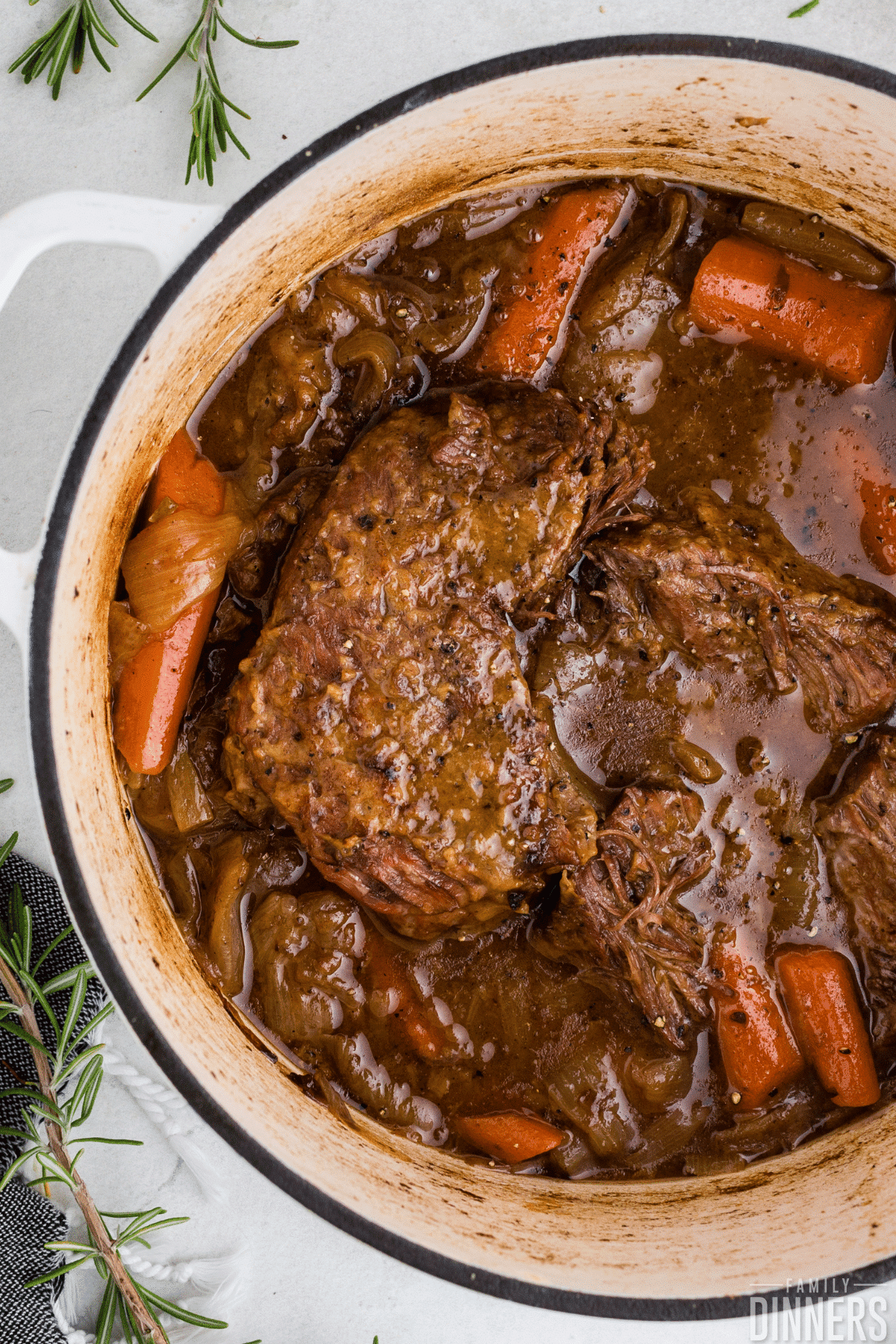 pot roast in a white dutch oven