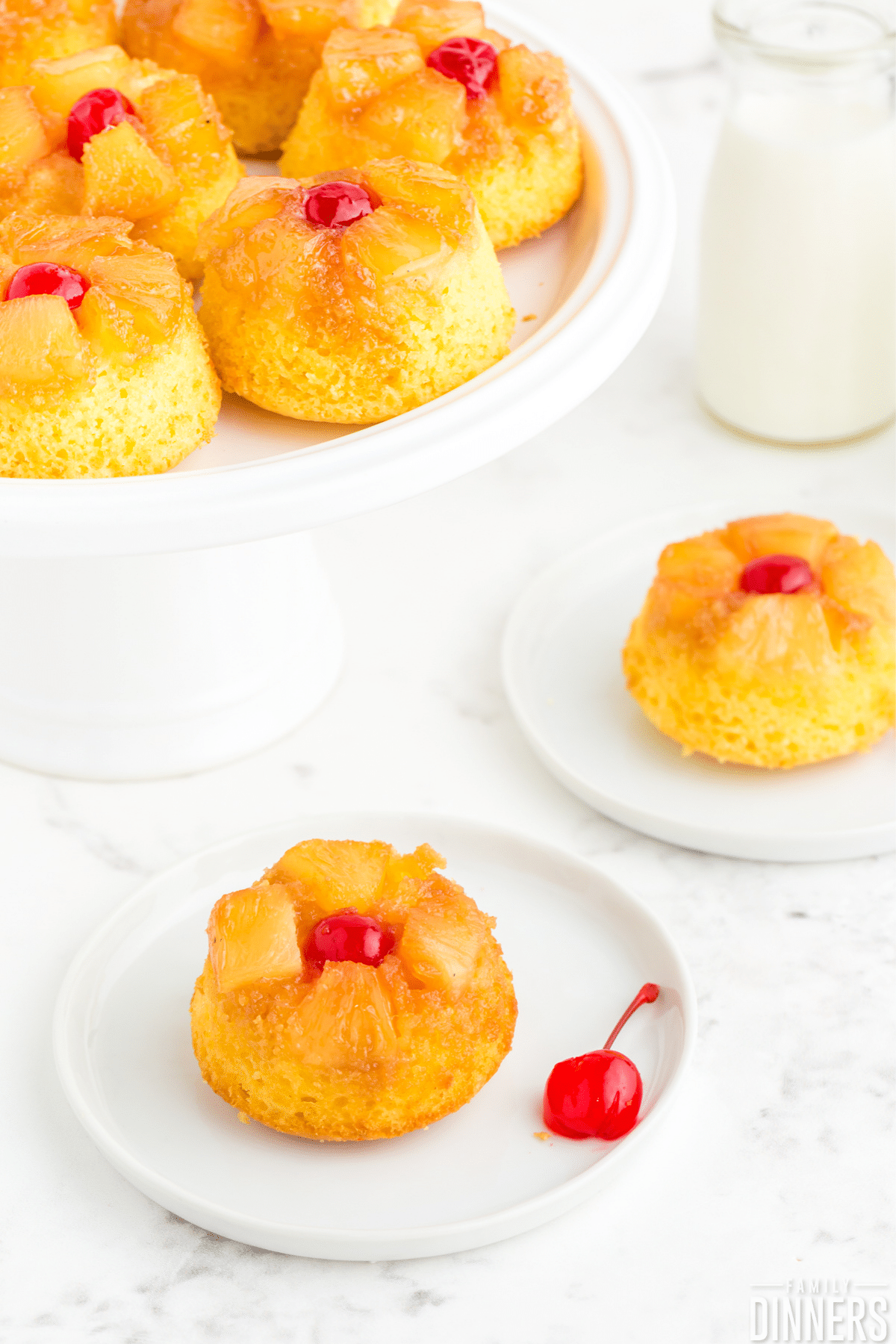 pineapple upside down mini cakes on a white plate