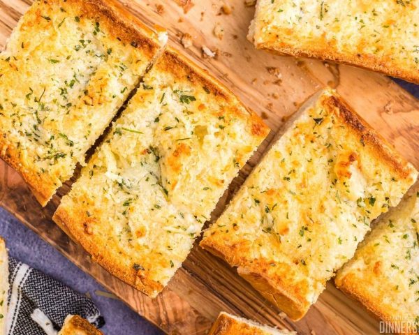 recommended recipe: garlic french bread golden roasted on wood cutting board