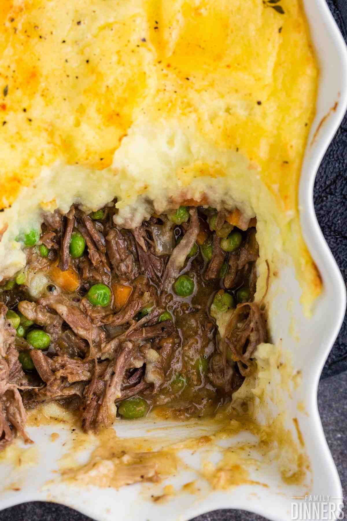 shepherd's pie recipe (easy cottage pie recipe) in a casserole dish with beef, peas and corn covered in potatoes