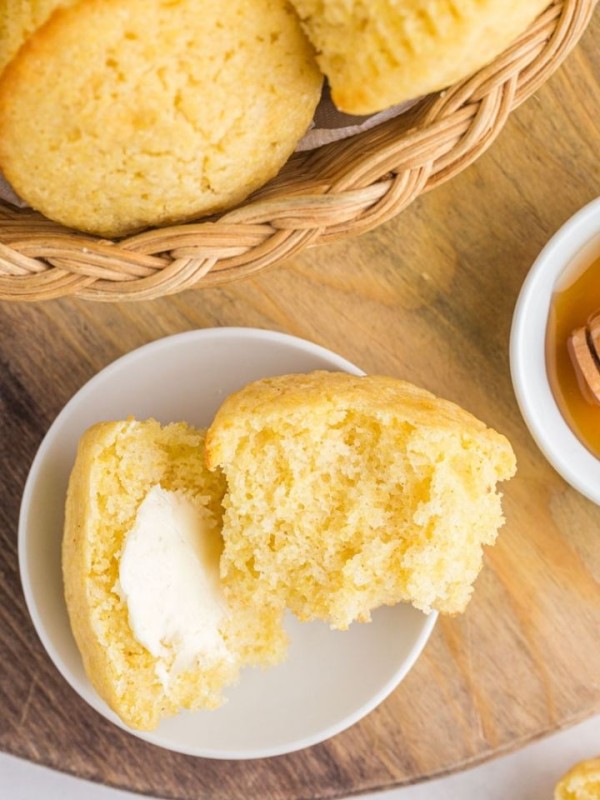 cornbread muffin open on plate with butter
