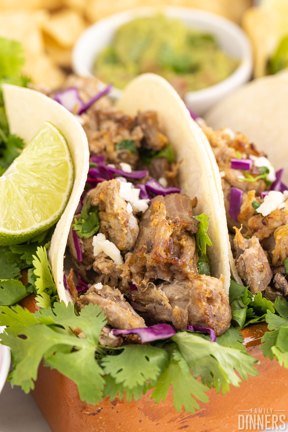 taco with instant pot carnitas meat, cabbage, lime and cilantro