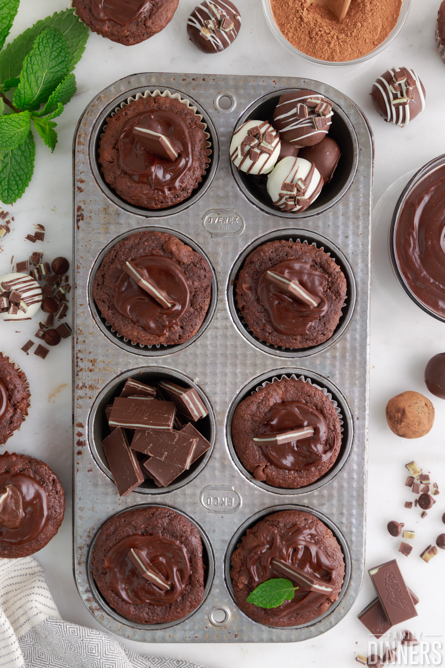 chocolate mint muffins in muffin tin with mint truffles