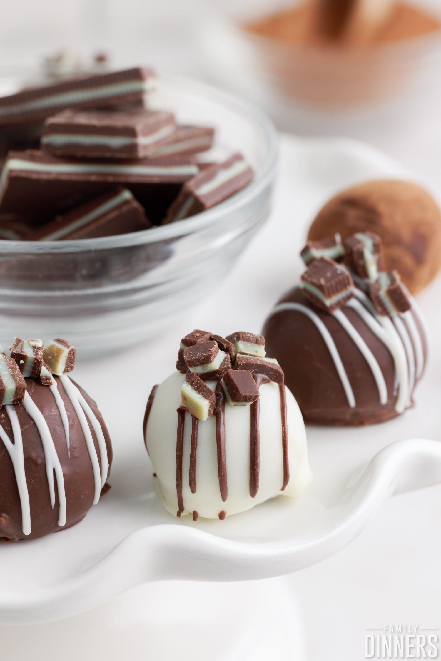 mint chocolate truffles around a glass bowl full of andes mints