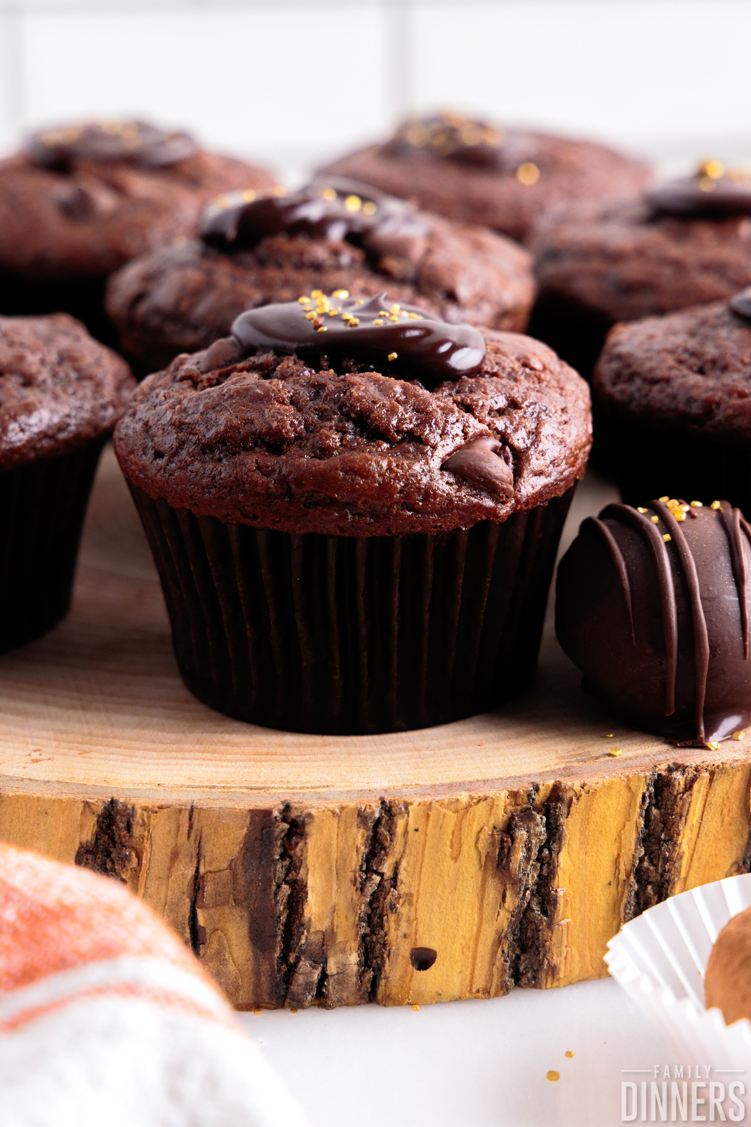 close up of chocolate rum muffins on a wooden board