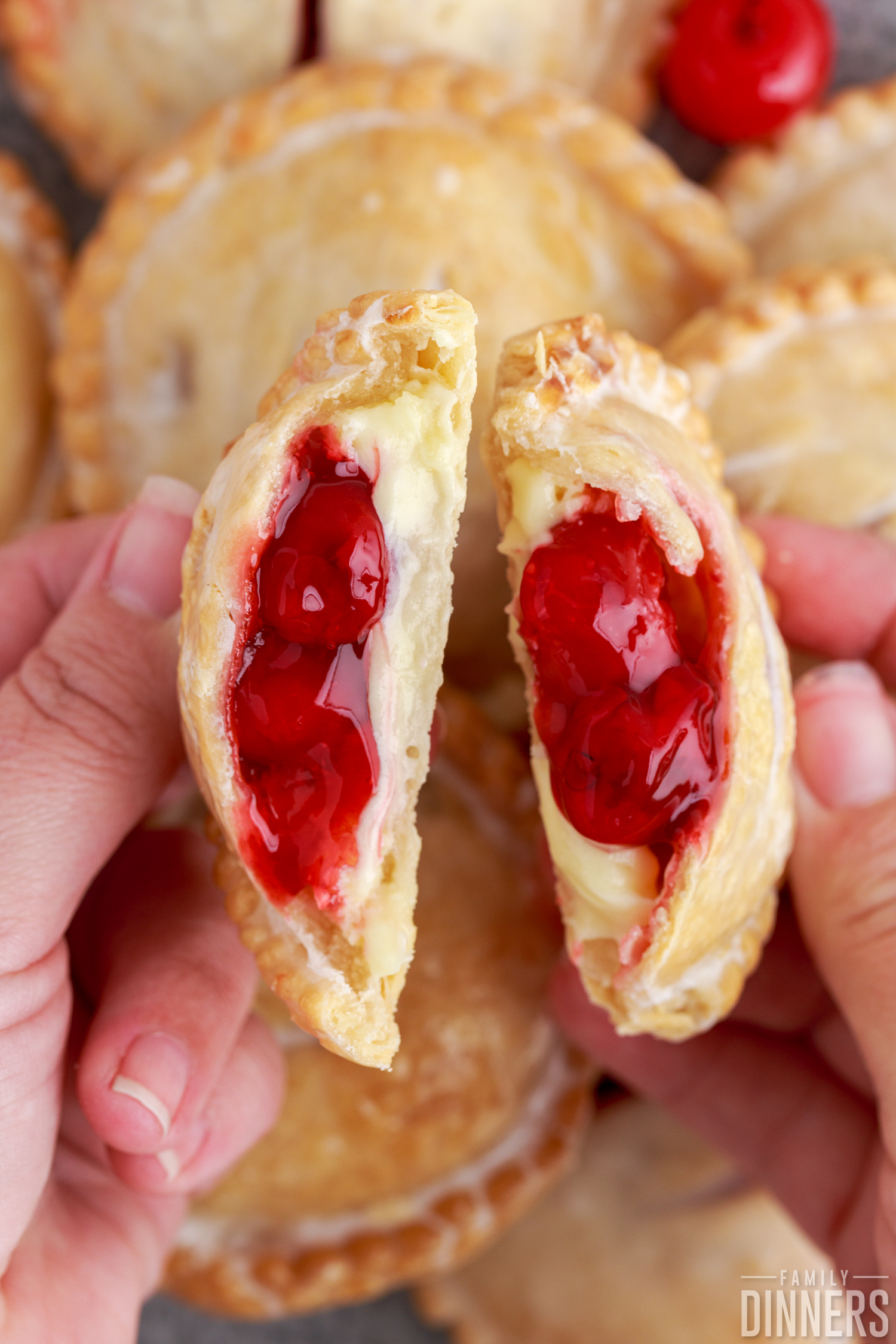 holding an air fried cherry hand pie with it broke open and the filling coming out
