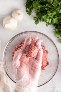 Hand rolling meatball into a round ball