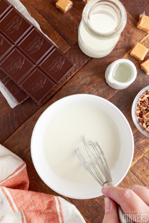 sugar glaze ingredients being whisked in a bowl