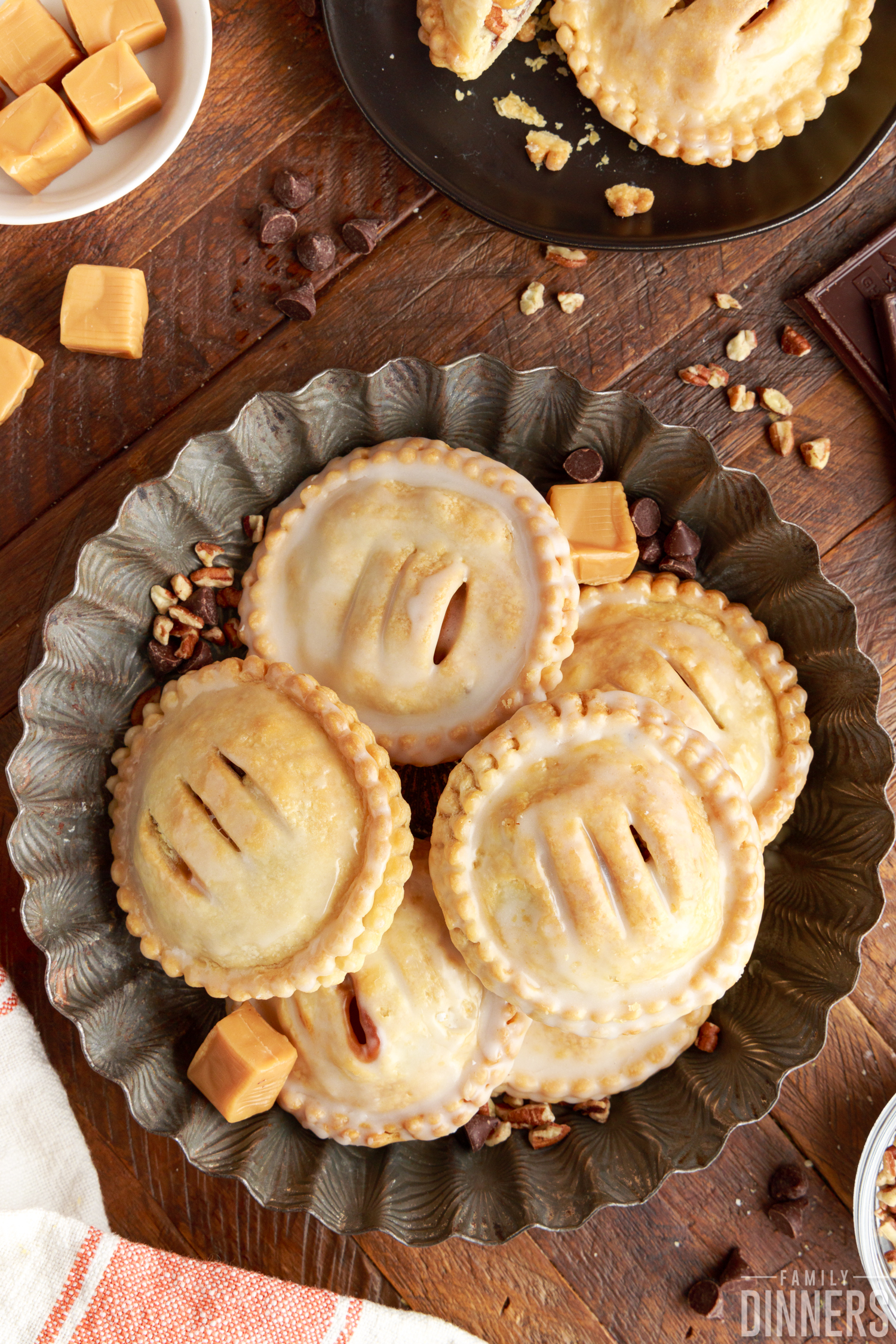 top shot of chocolate, caramel, and pecan hand pies in a serving dish