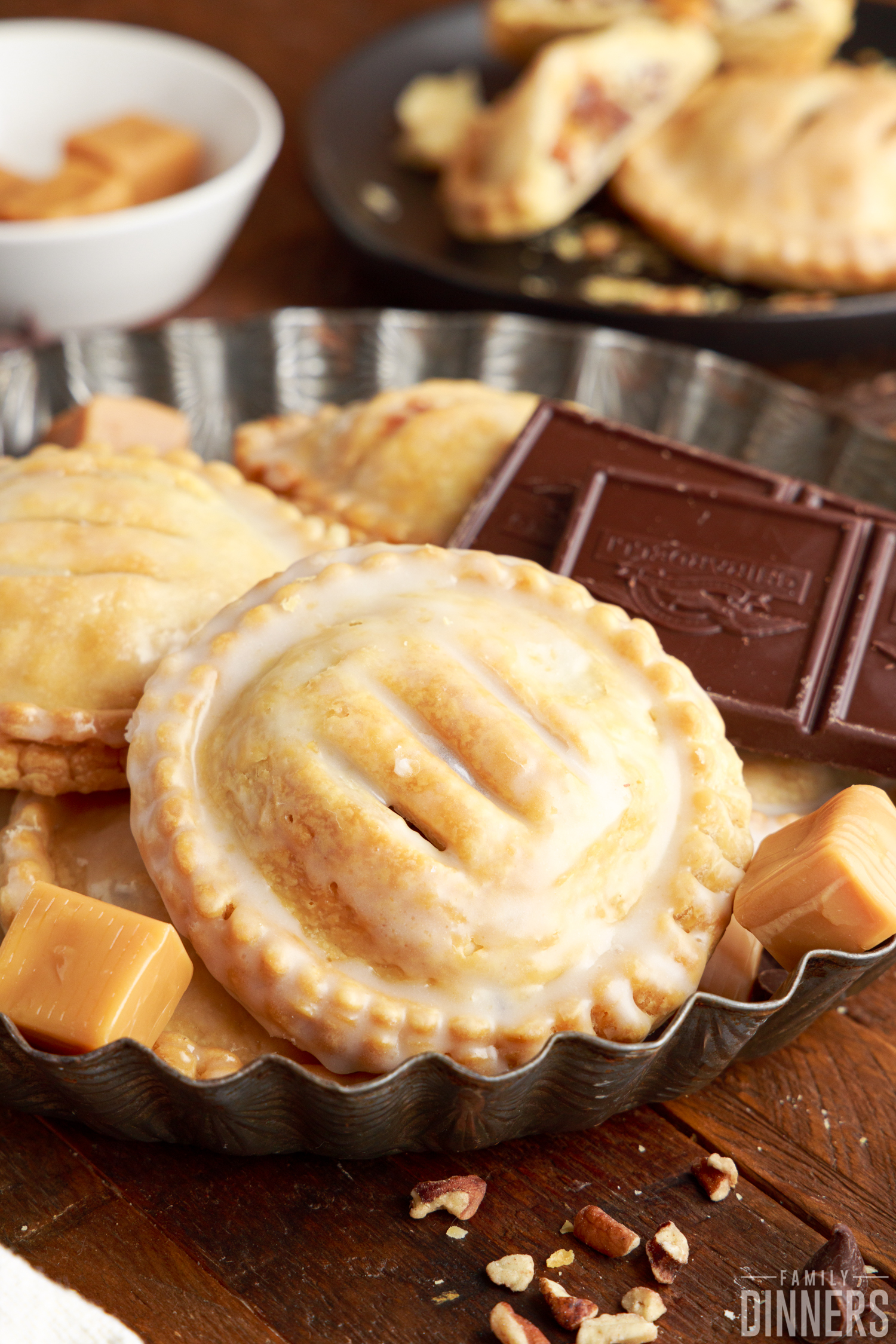 air fryer hand pies with a homemade glaze next to chocolate and caramel