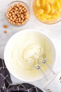 cream cheese mixture with beaters in a bowl