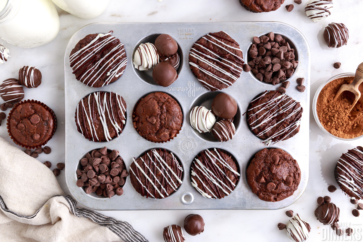 double chocolate muffins in a muffin tin with truffles and chocolate chips