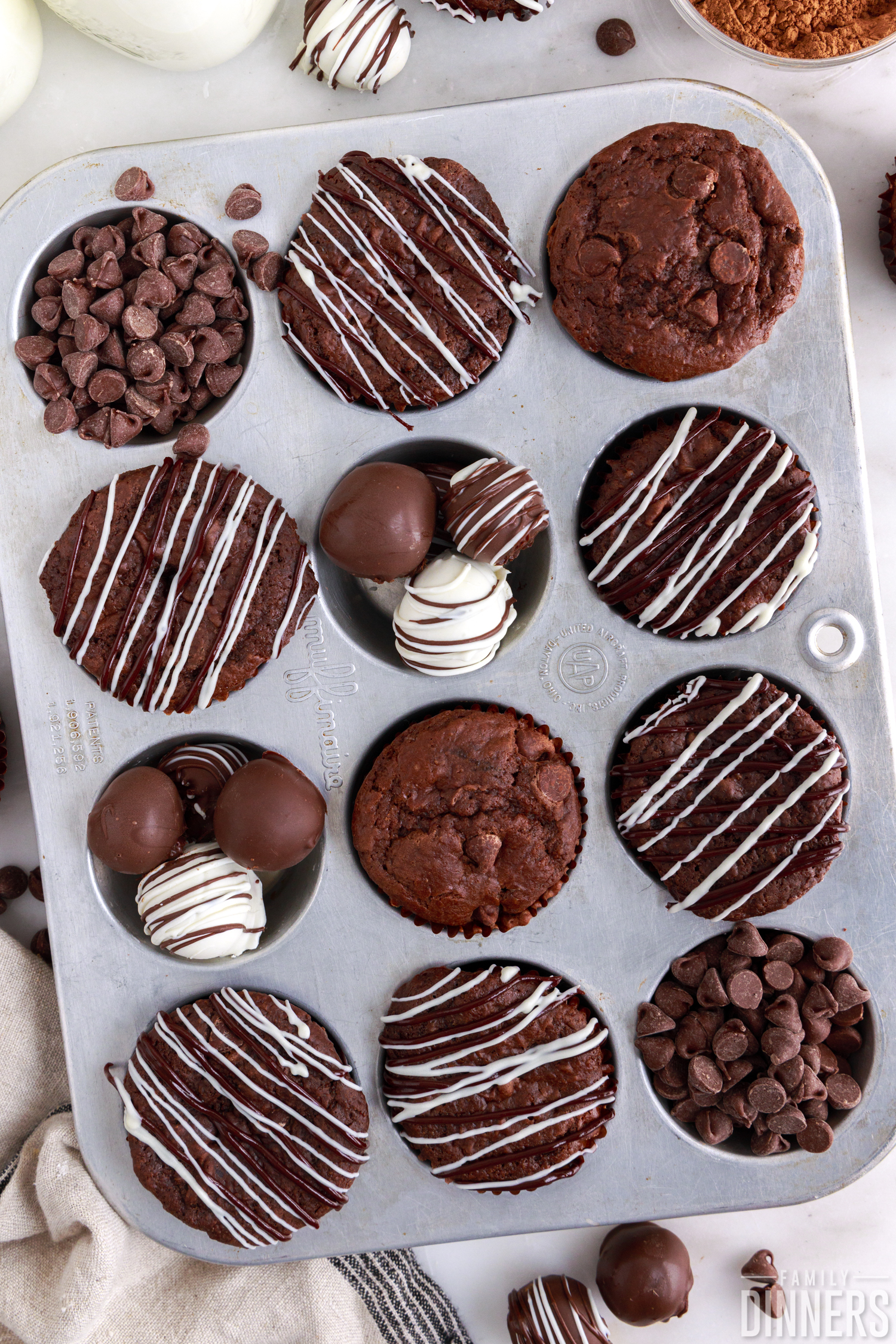 double chocolate molten muffins in a muffin tin with truffles and chocolate chips