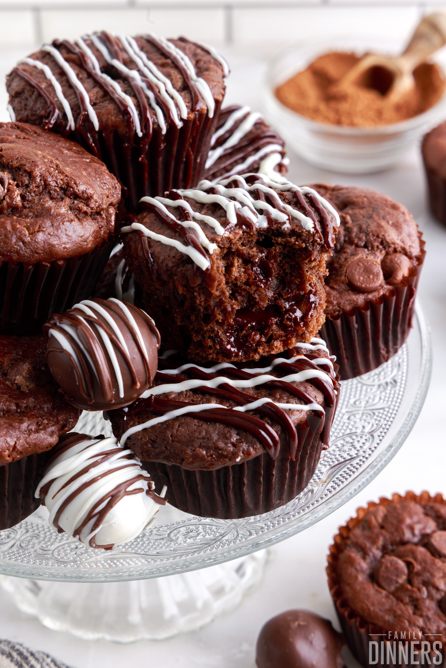 Chocolate molten lava muffins with truffles on a glass cake stand