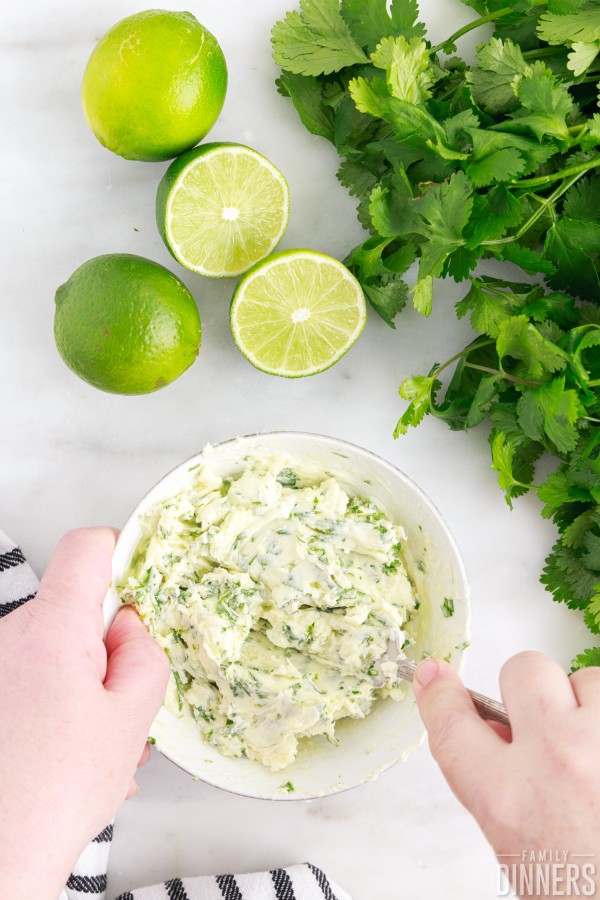mixing cilantro lime rice ingredients in a bowl