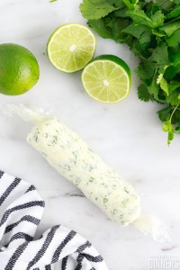 cylinder of cilantro lime butter in plastic wrap