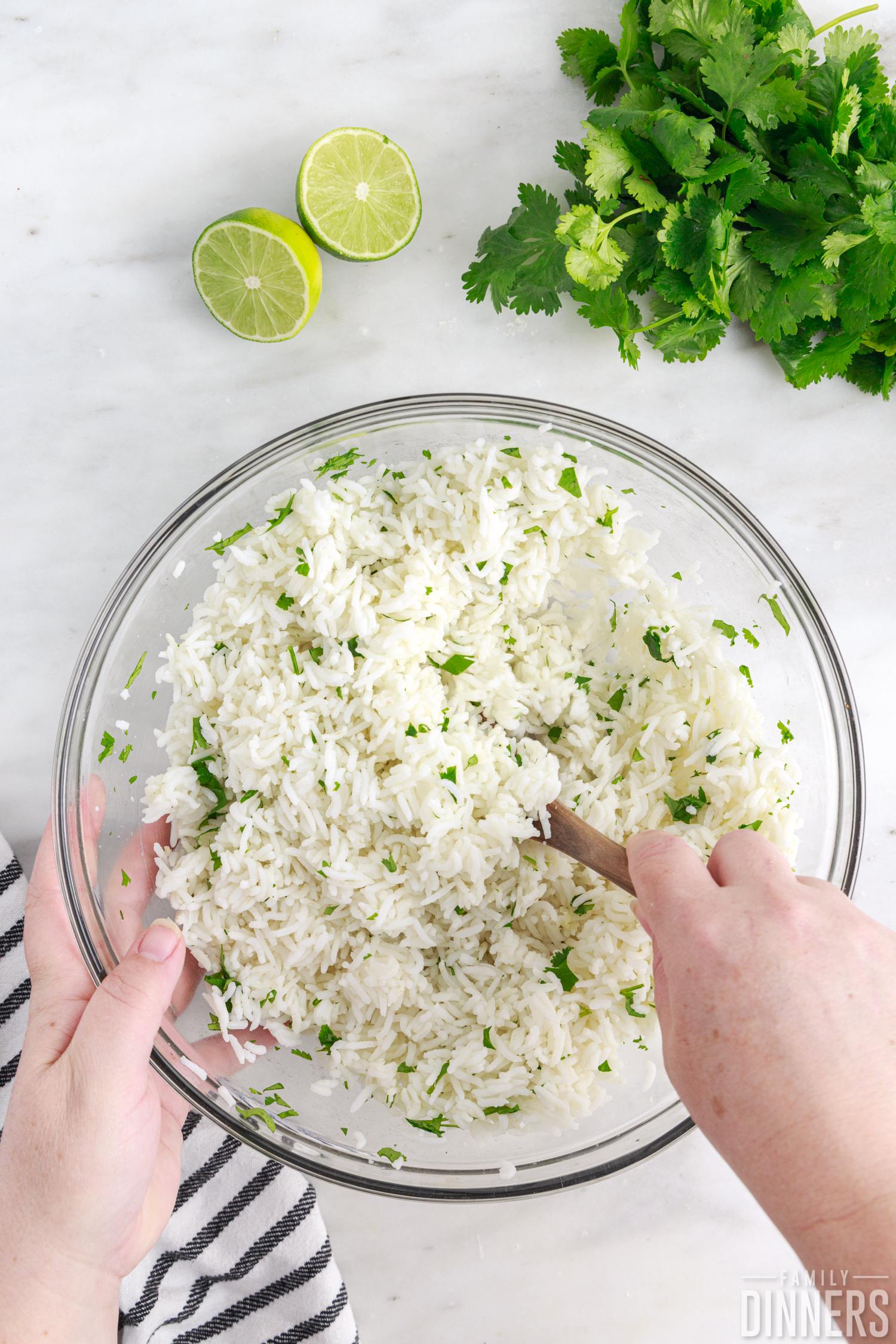 hands mixing cilantro lime rice