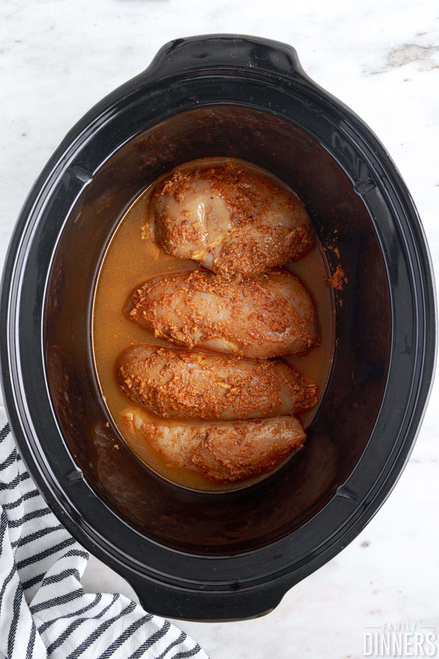 chicken breasts in liquid in a crock pot