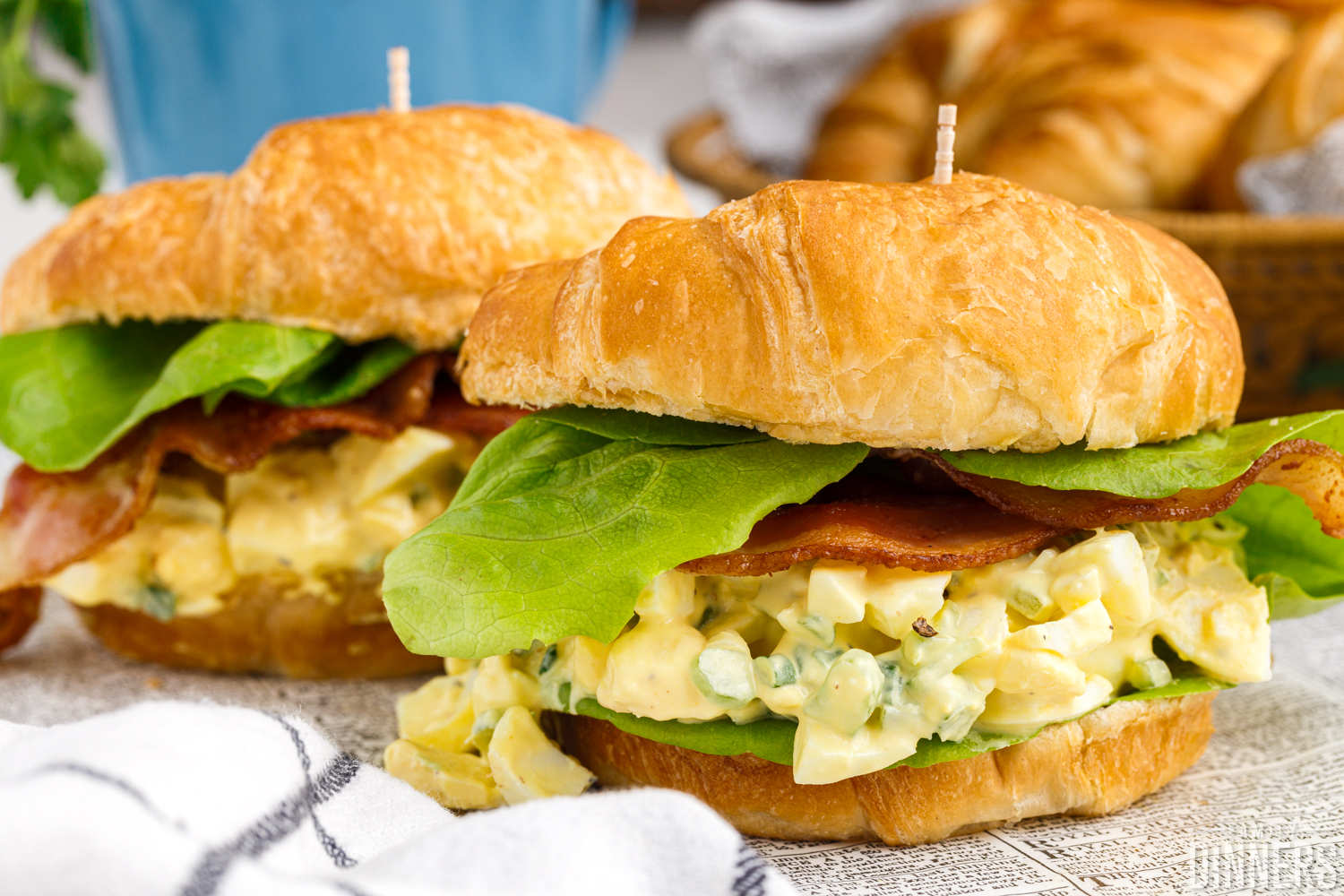 Completed egg salad sandwiches on a croissant.