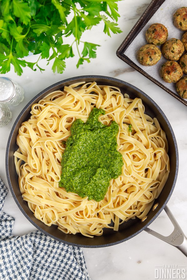 pan of fettuccine with pesto on top