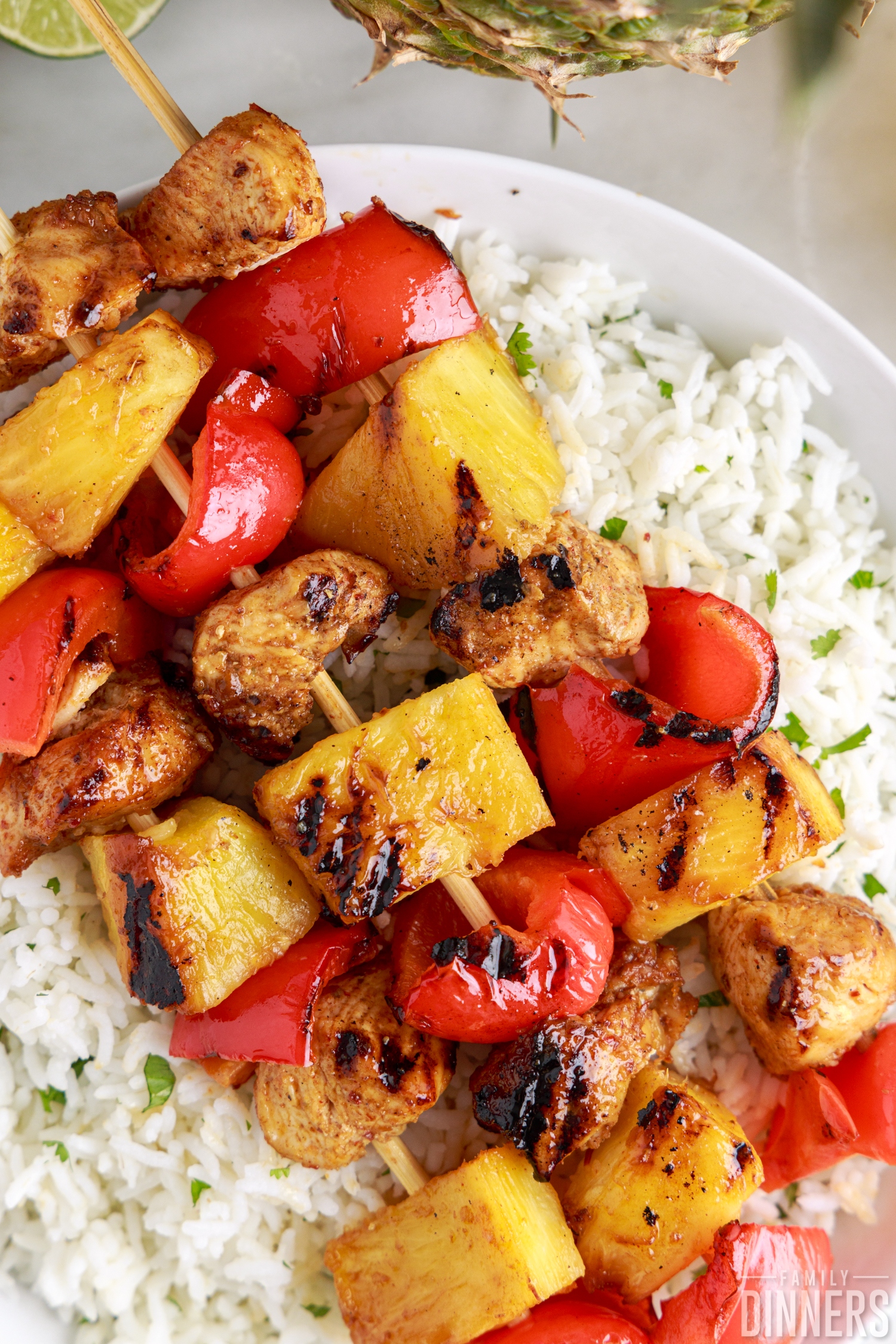 three chipotle chicken kabobs laying on a bed of cilantro lime rice