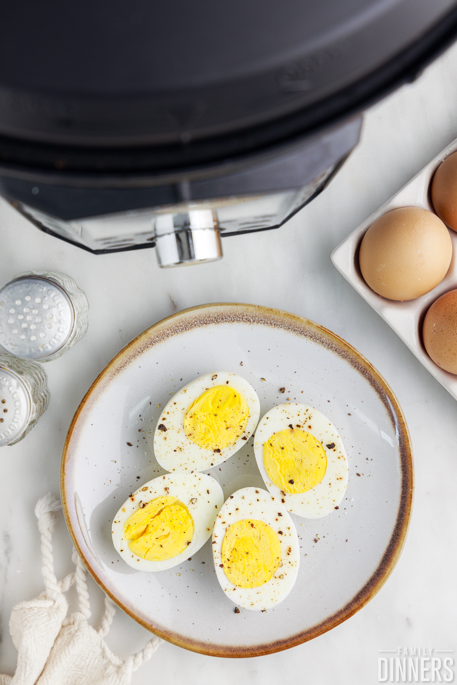 cut open hard boiled eggs next to an instant pot