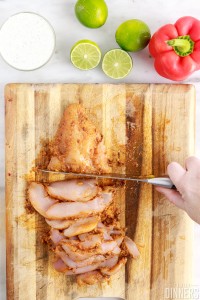 knife cutting up chicken breast