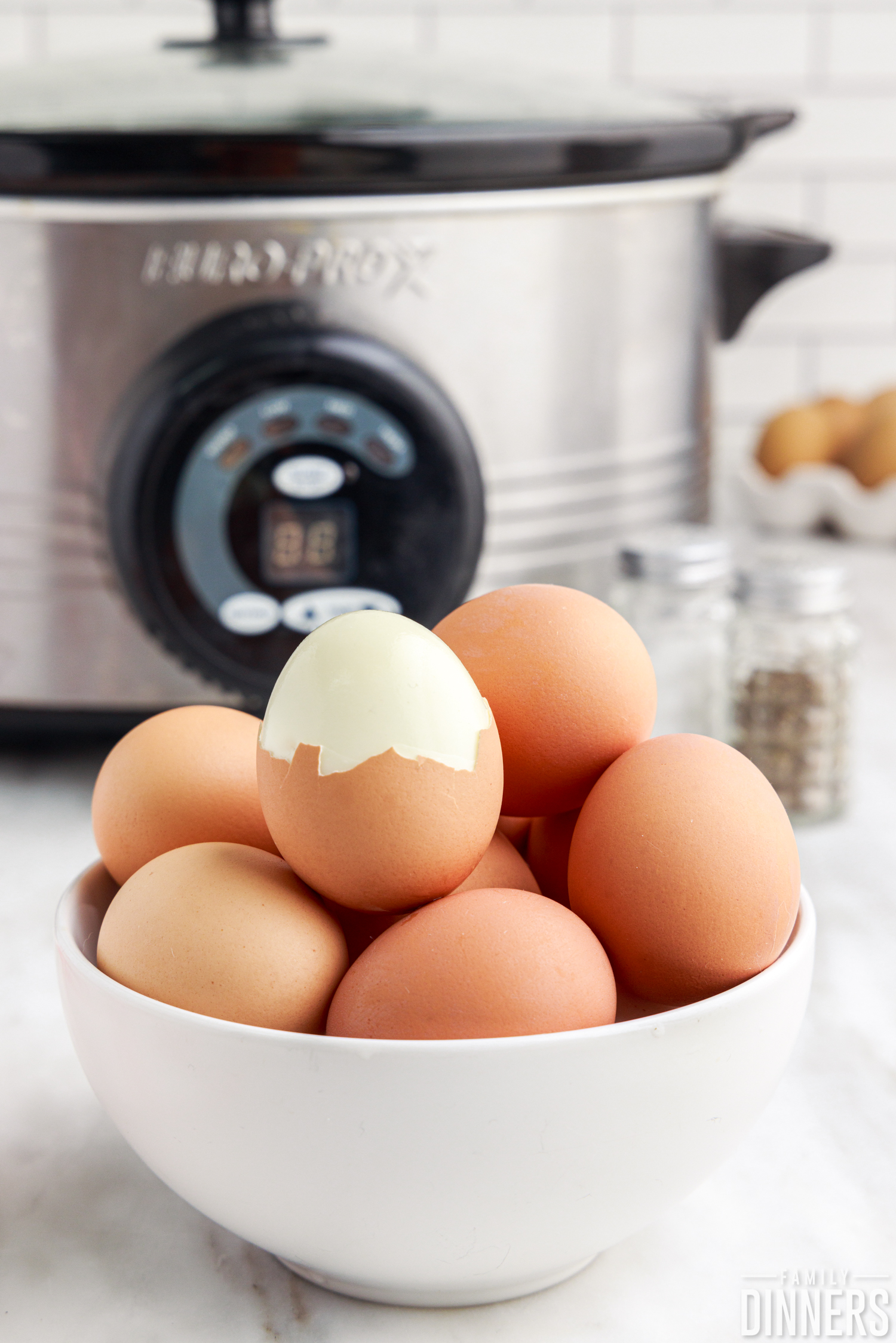 bowl of brown eggs in front of a crock pot