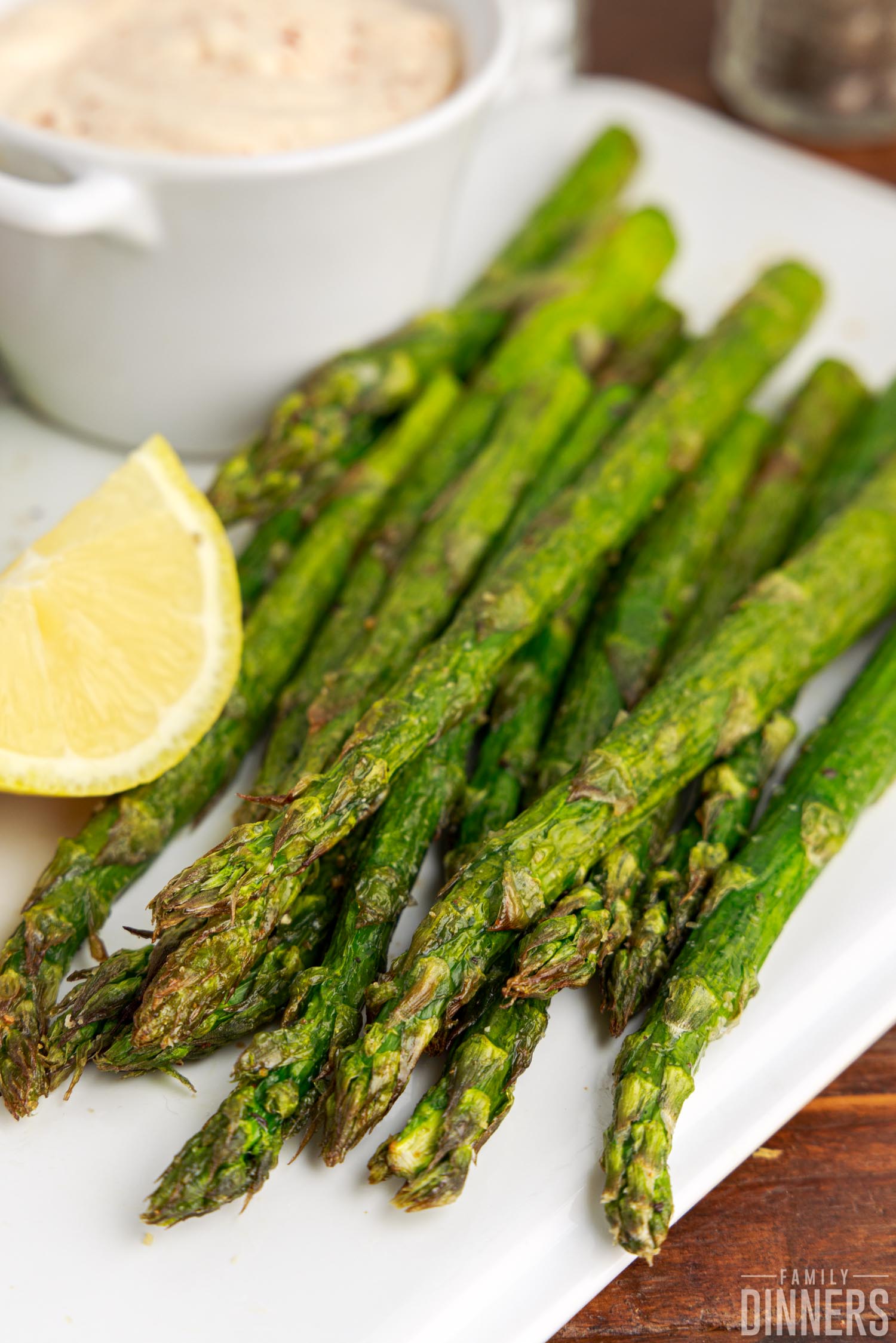 A seasoned batch of cooked asparagus stems on a plate.
