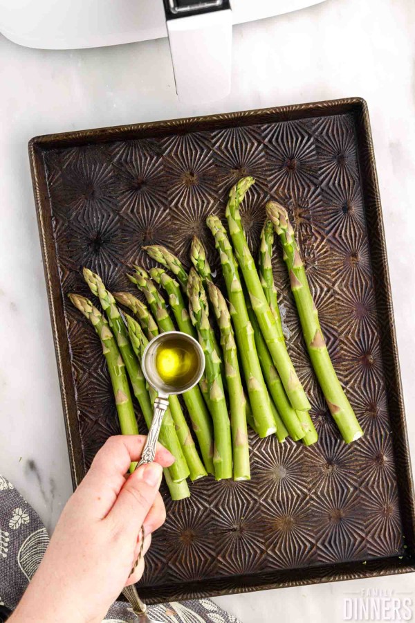 oil drizzled over asparagus