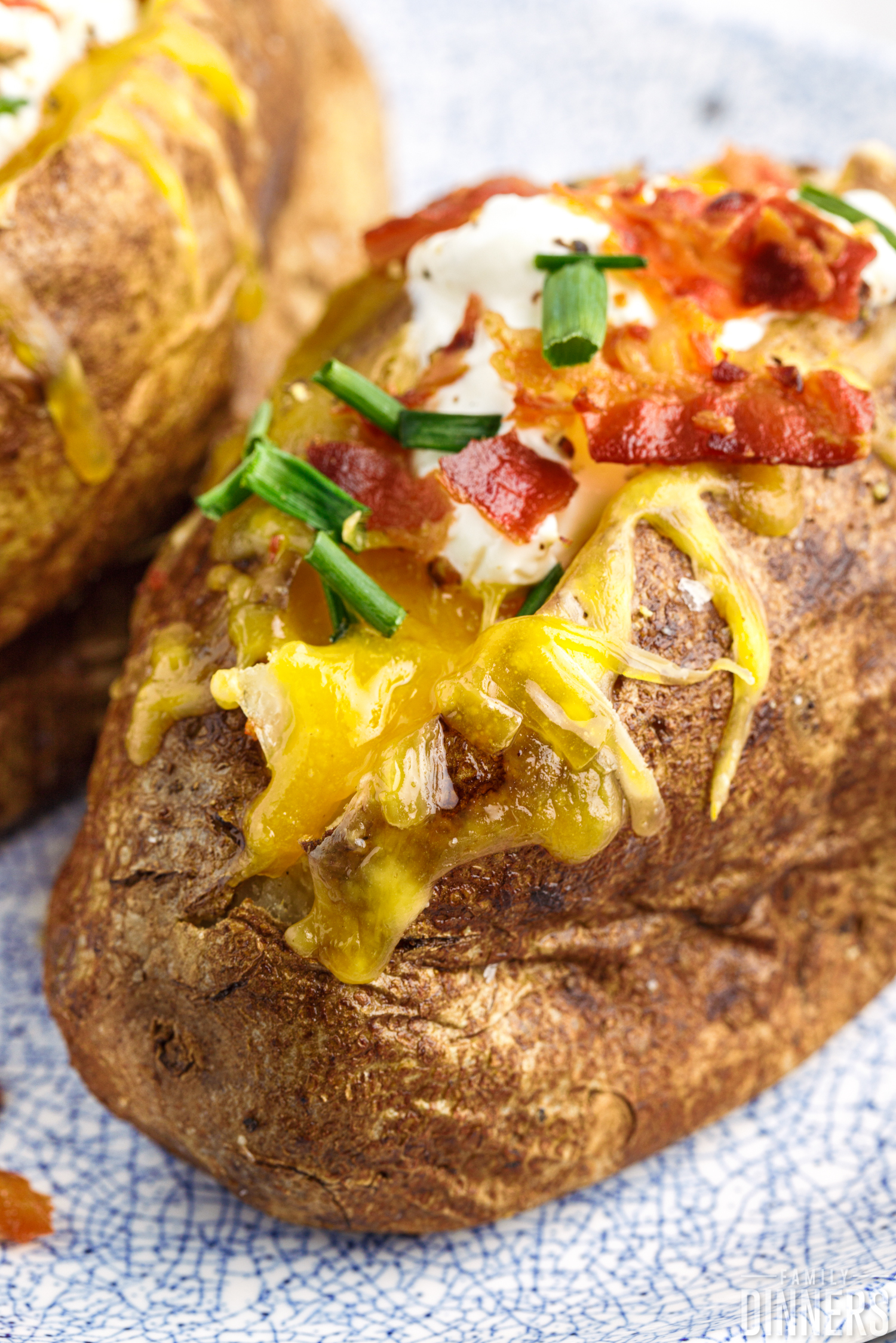 close up of a baked potato with toppings