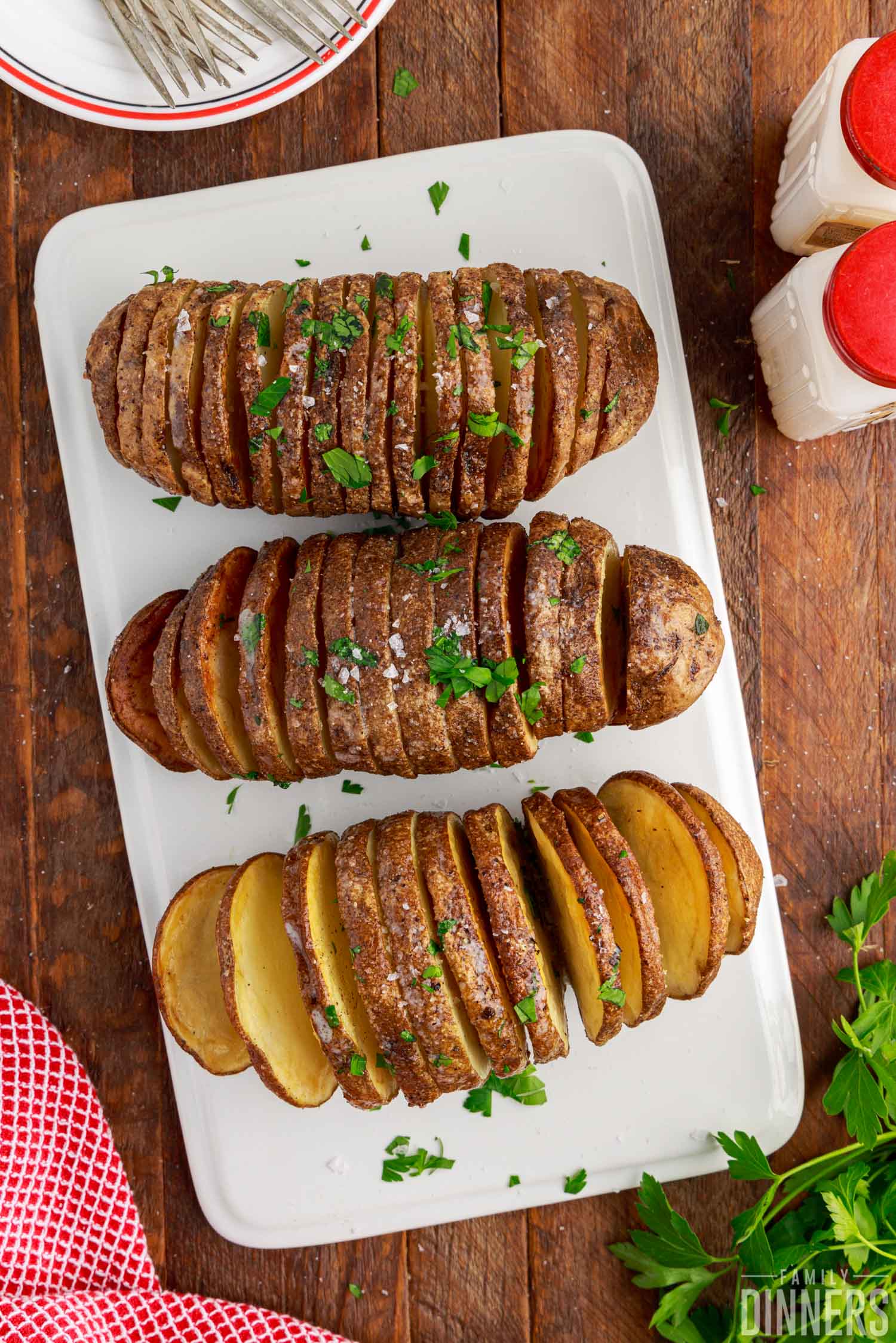 Fully cooked air fryer hasselback potatoes on a plate.