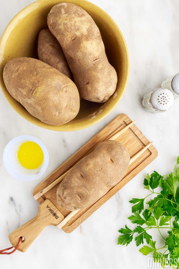 chopsticks laying next to potato