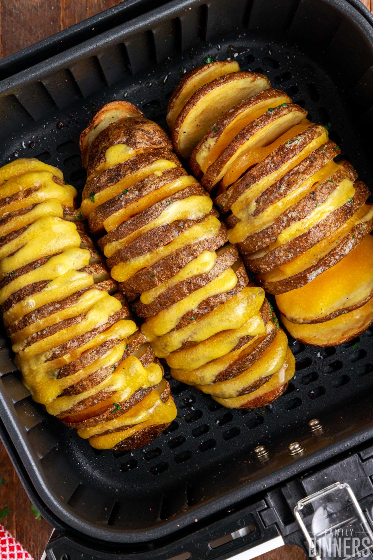 cheesy hasselback potatoes in air fryer basket