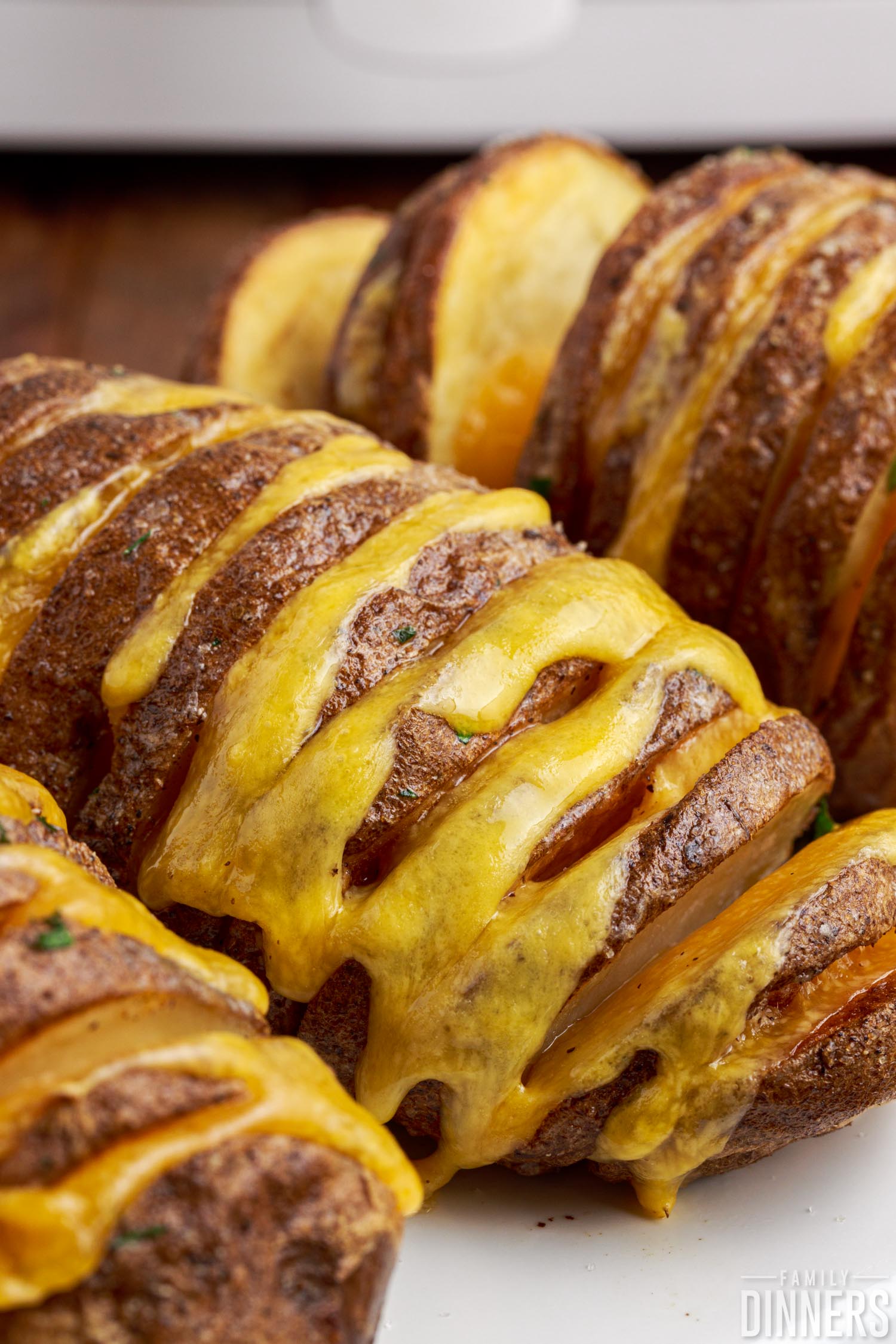 Close up of cheesy hasselback potatoes.