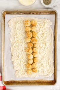 chicken meatballs lined up on middle of dough