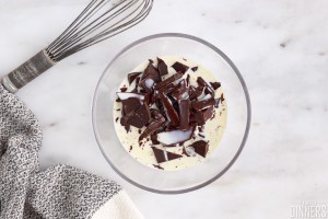 chopped chocolate and cream in a glass bowl