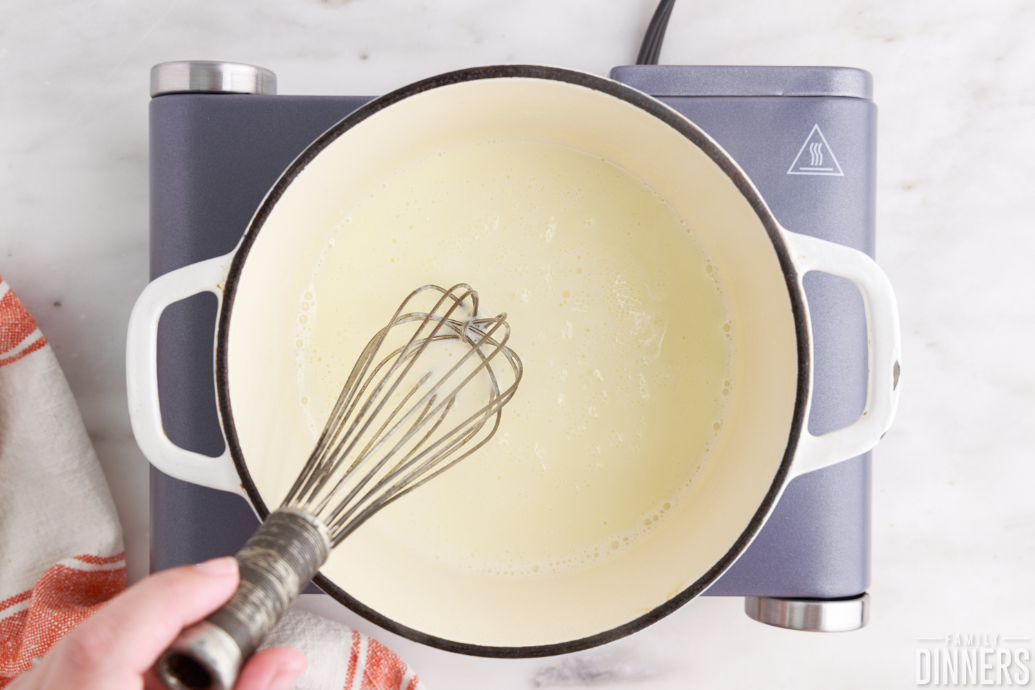 heating heavy cream in a pan