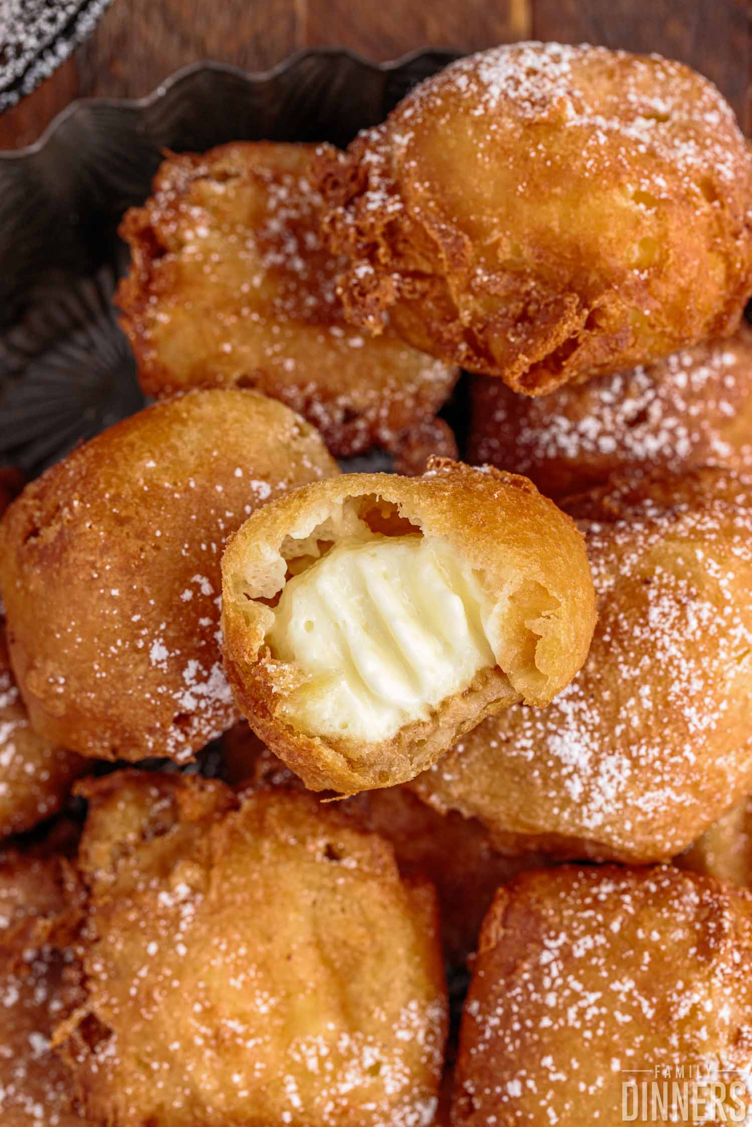 deep fried cheesecake with bite taken set on a pile of cheesecake balls