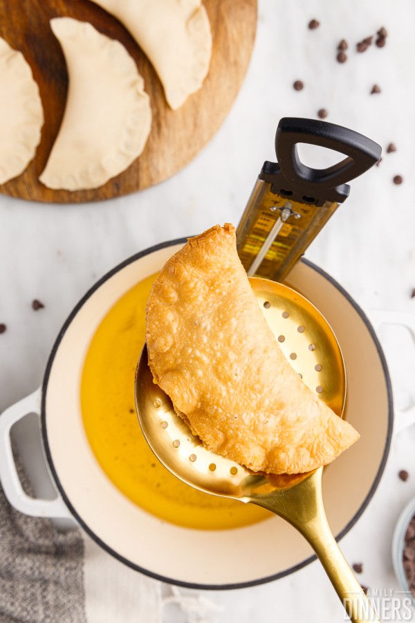 deep fried chocolate peanut butter cheesecake hand pie on a spatula