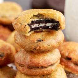 stack of deep fried oreos with one having a bite taken out