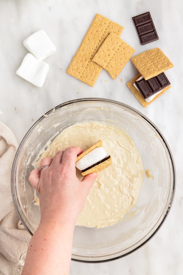 s'more being dipped into batter