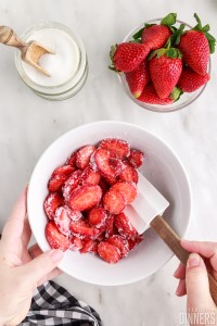 mixing sugared strawberries with a spatula