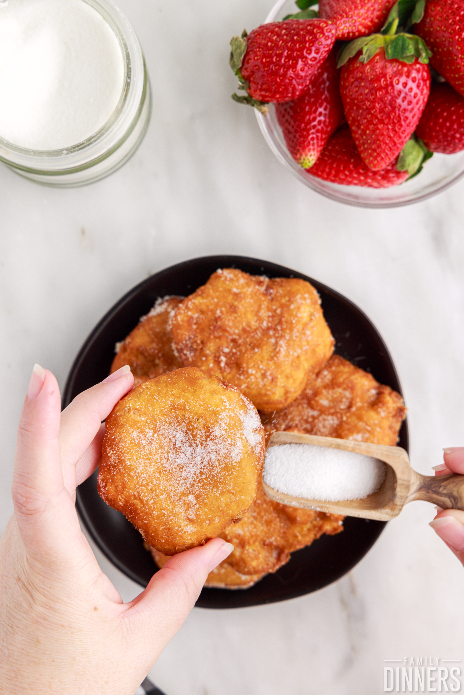 sugar pouring on deep fried biscuits