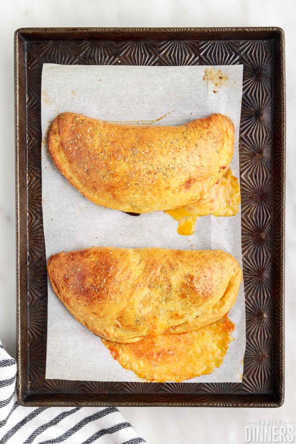 cooked calzones on baking sheet