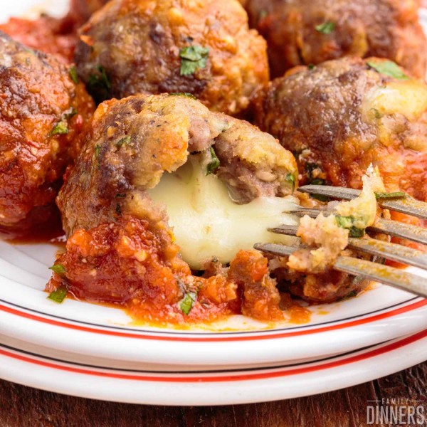 meatball with mozzarella cheese oozing out of the middle