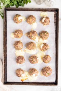 cooked meatballs on baking sheet