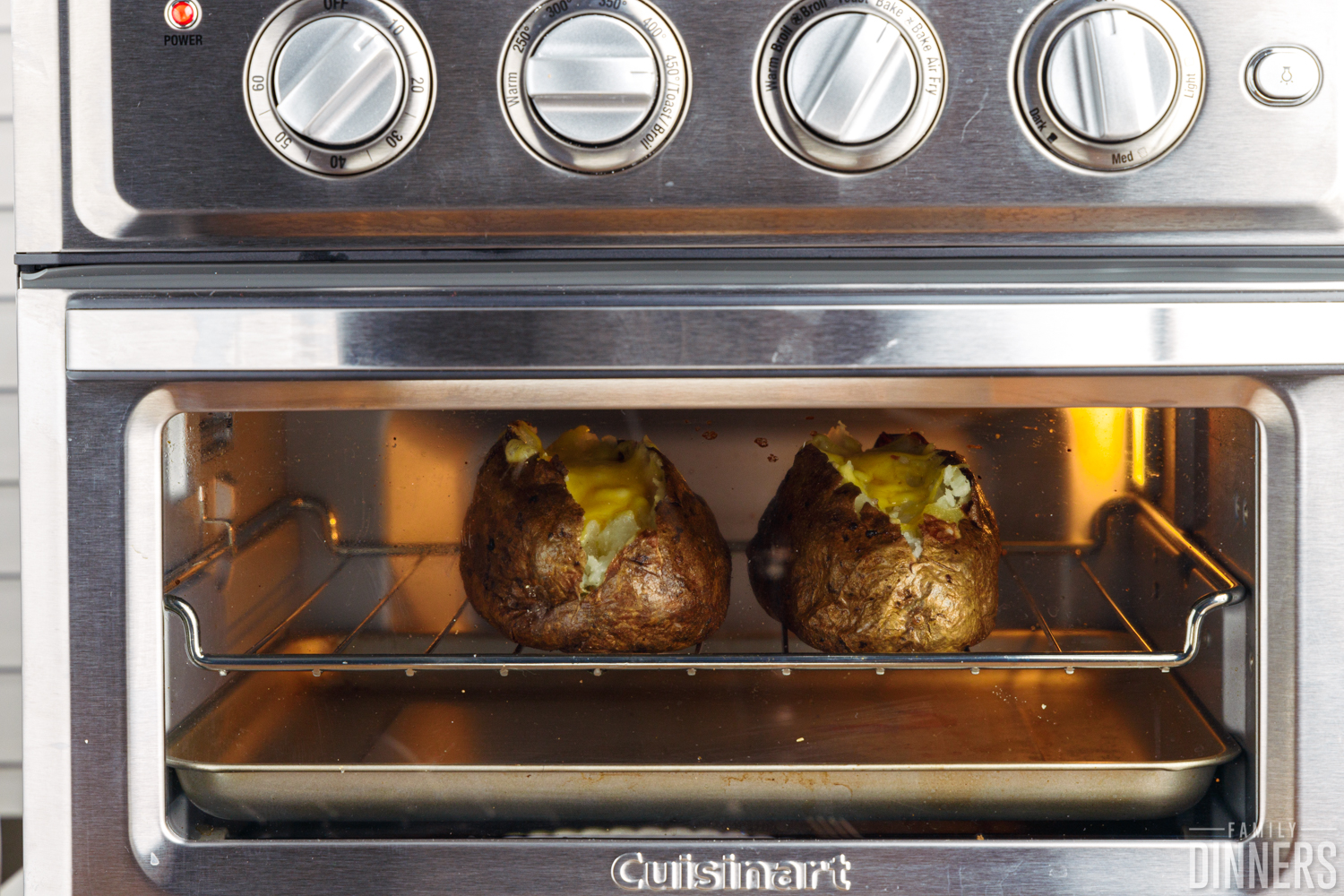 baked potatoes in the toaster oven loaded with cheese